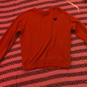 A v neck orange brown with a black Mickey logo